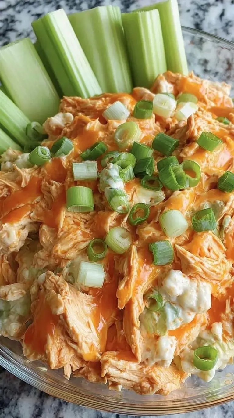 Creamy buffalo chicken salad with celery and blue cheese served over fresh mixed greens