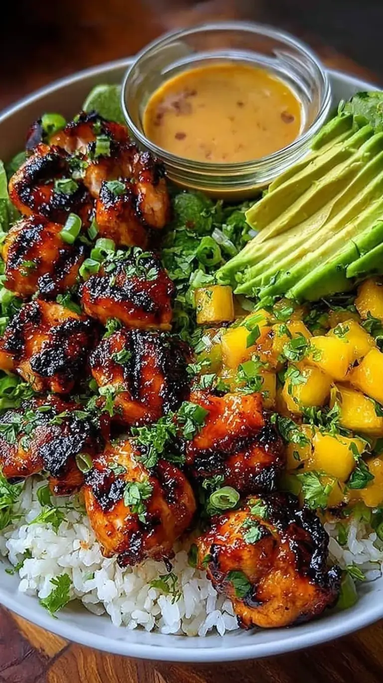 Grilled Maple Sriracha Chicken bites served over a bed of fluffy coconut jasmine rice with green onions