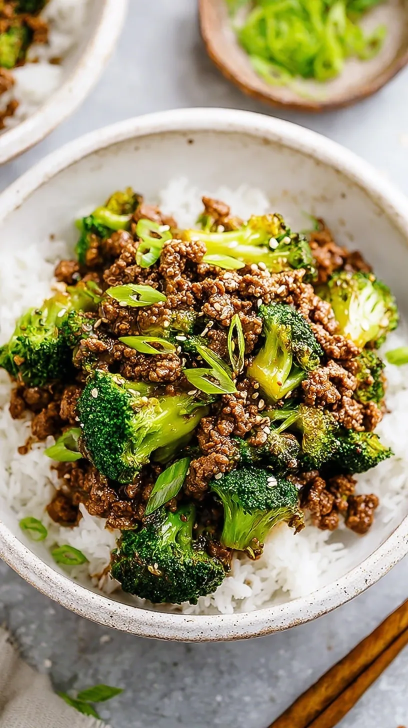A skillet filled with savory ground beef and tender-crisp broccoli florets in a glossy brown sauce.