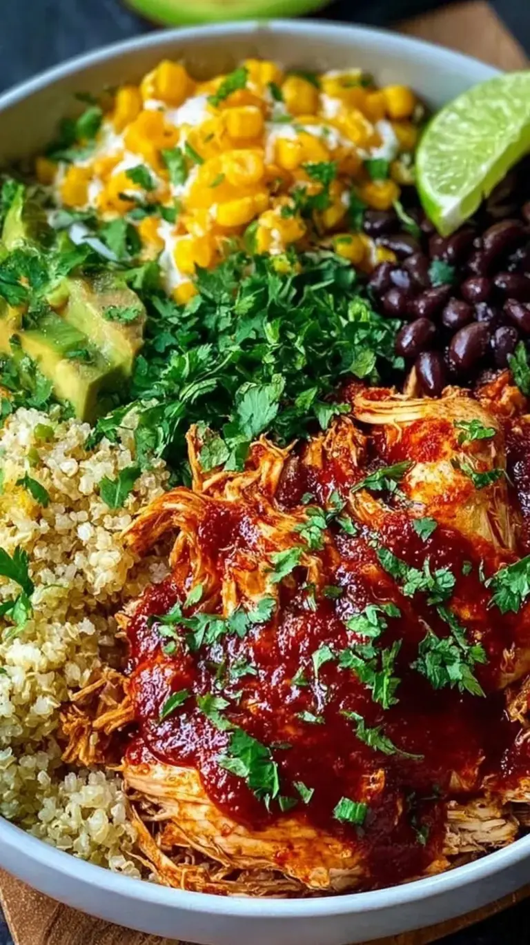 Four meal prep containers filled with quinoa, shredded chicken, black beans, corn, and melted cheese topped with cilantro.