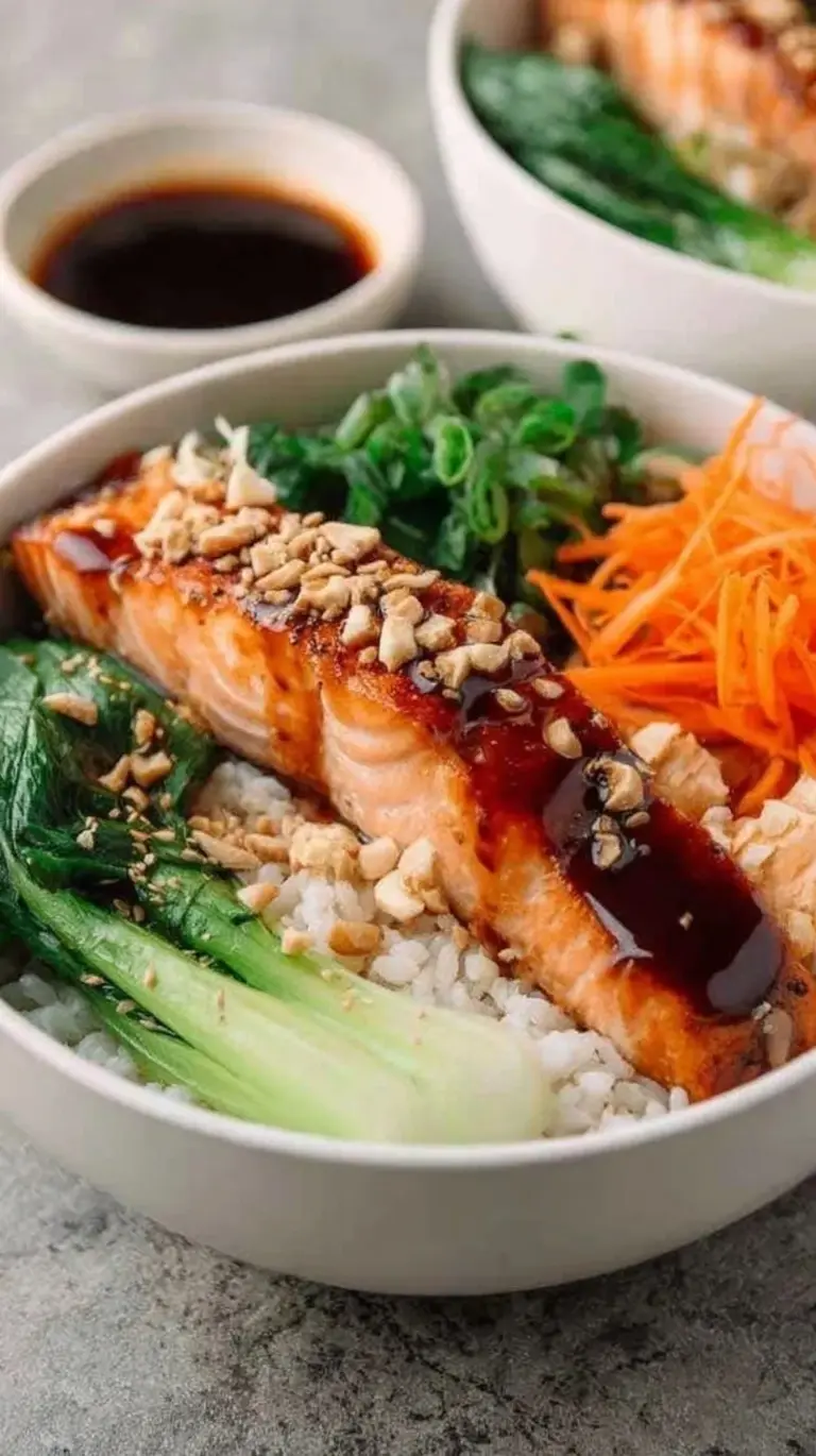 Pan-seared teriyaki salmon fillet over a bed of cauliflower rice and steamed broccoli topped with sesame seeds