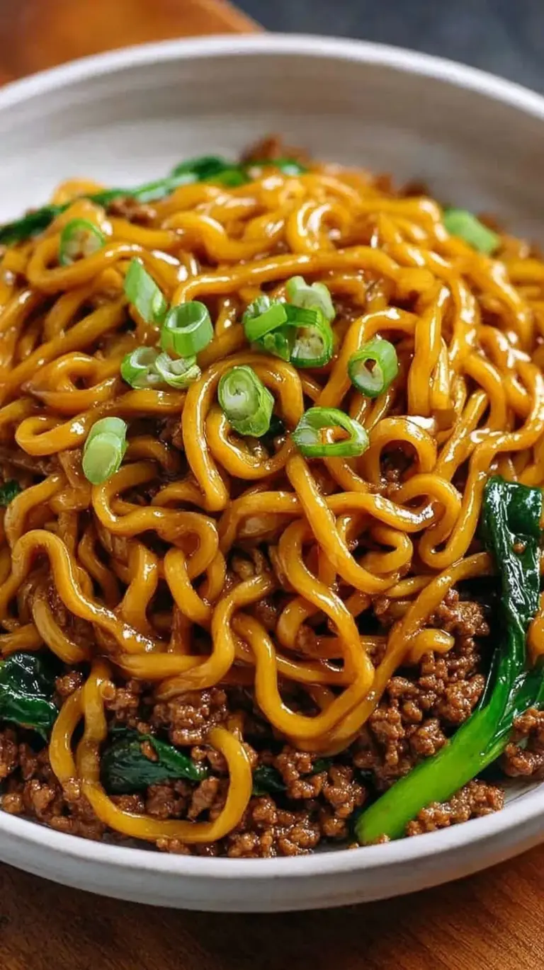 A steaming bowl of High Protein Mongolian Noodles with sliced beef and broccoli