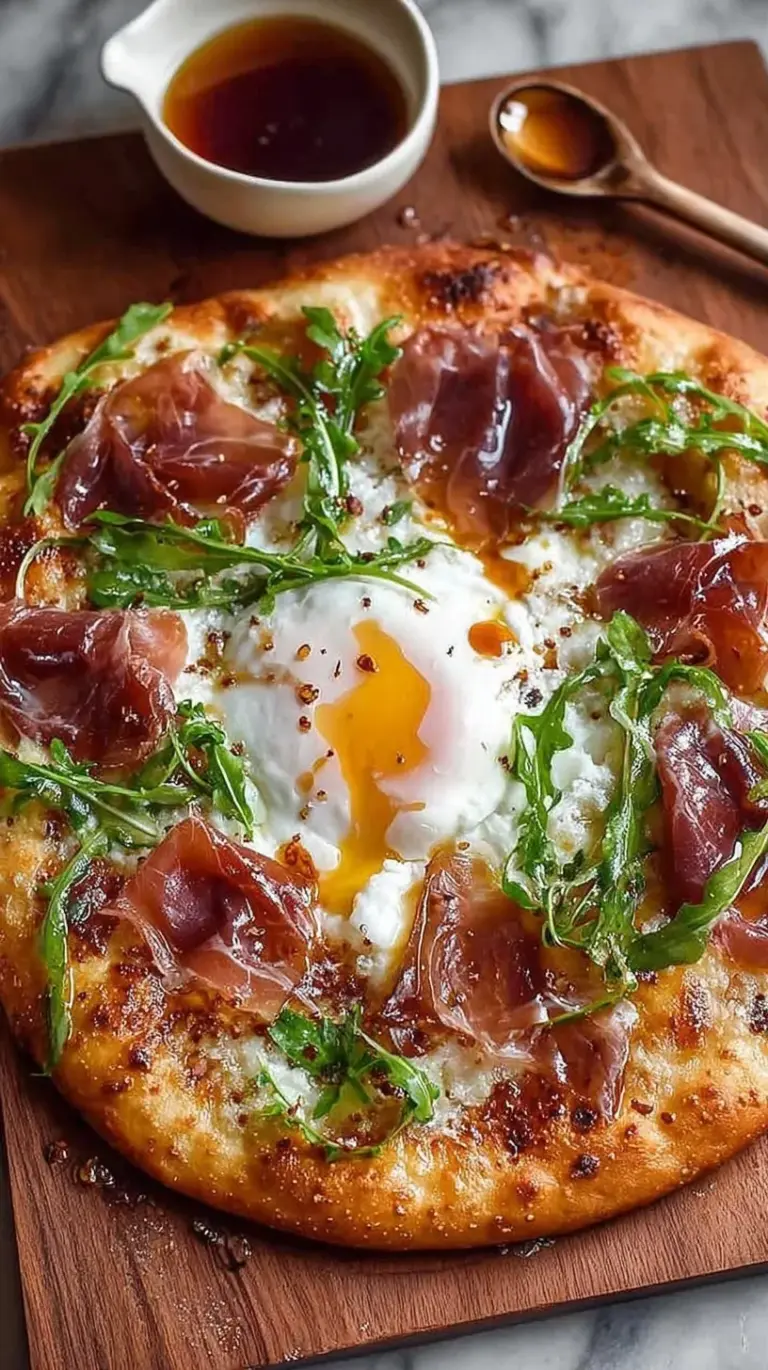 Artisanal high protein pizza topped with fresh burrata, thin prosciutto slices, arugula, and a drizzle of hot honey