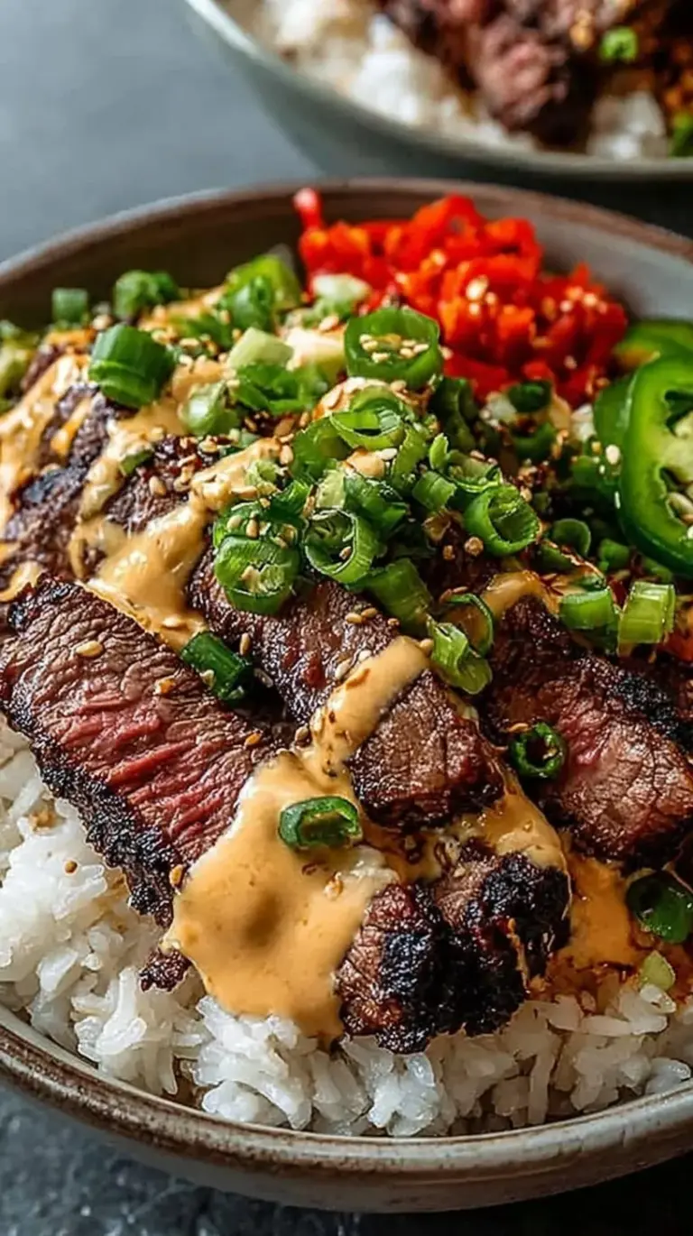 A vibrant Korean BBQ steak rice bowl with cucumbers, kimchi, and a drizzle of spicy cream sauce.