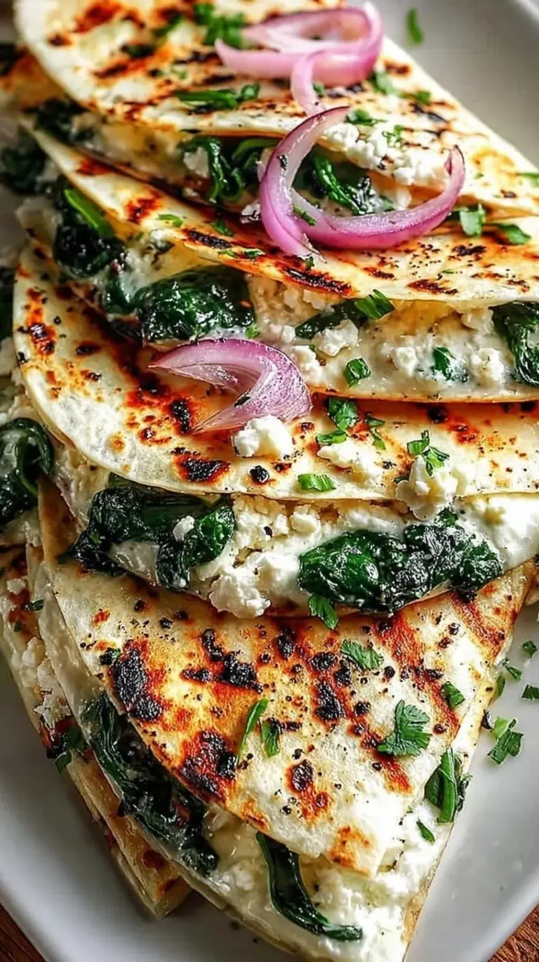 Golden brown Mediterranean Spinach Feta Quesadillas sliced into wedges on a wooden board