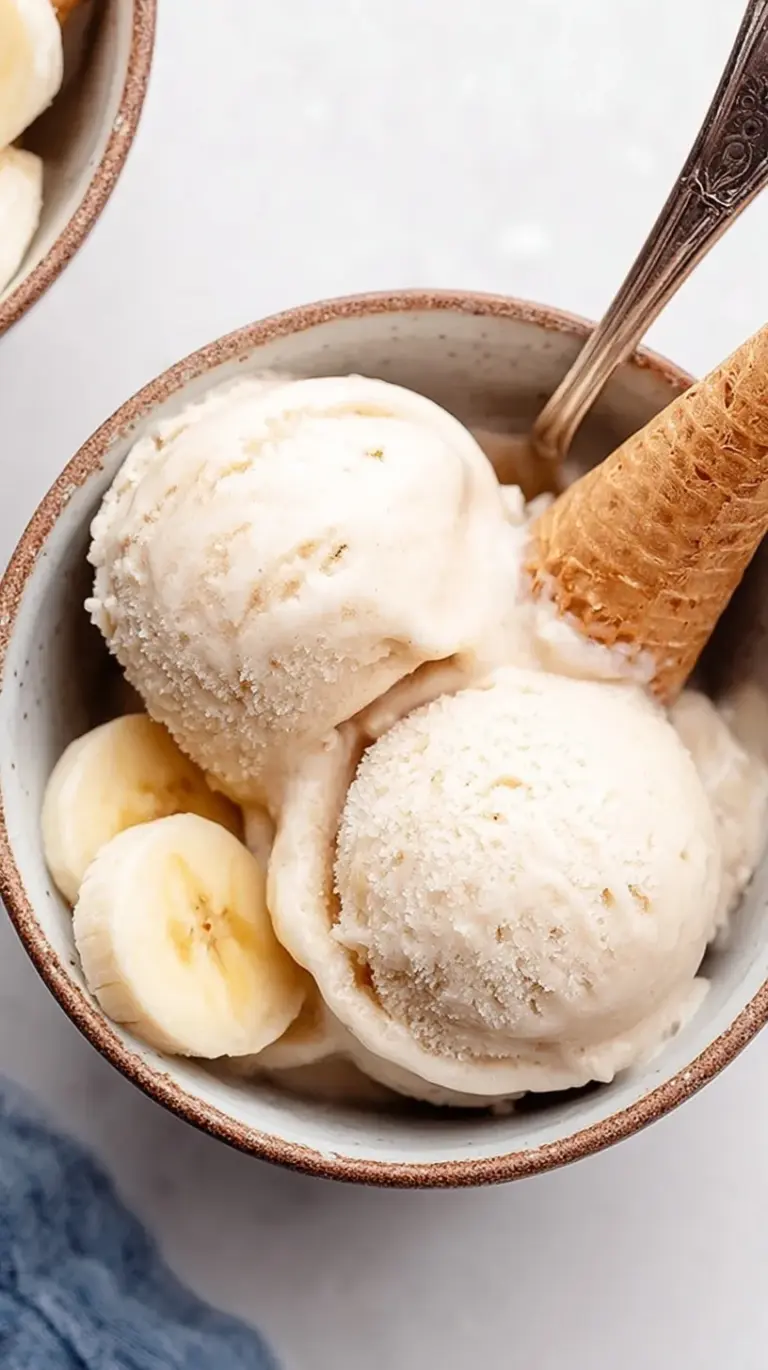 A bowl of creamy, soft-serve style banana ice cream made with only one ingredient.