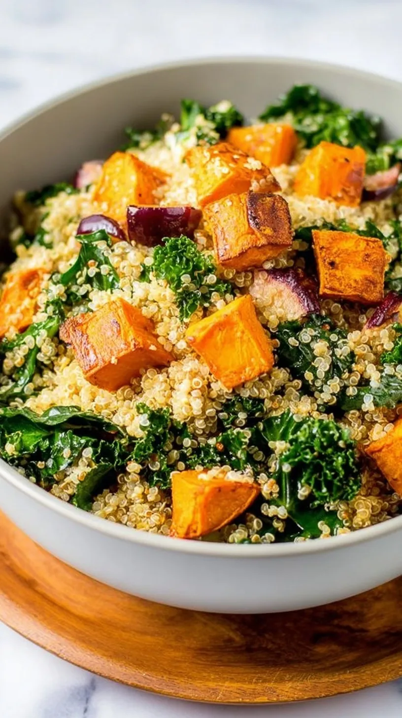 A vibrant bowl of quinoa kale sweet potato salad topped with toasted pumpkin seeds