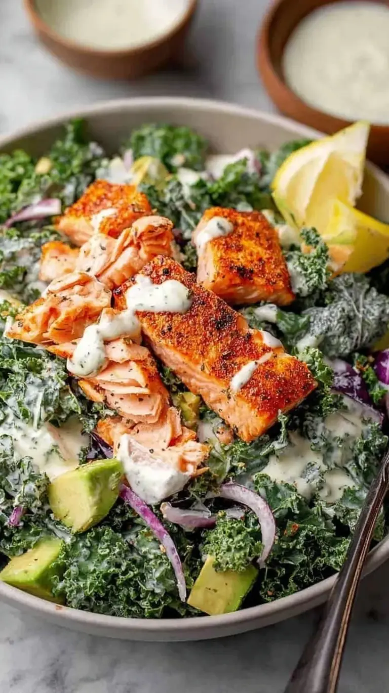 Pan-seared salmon fillet on a bed of massaged kale with creamy Caesar dressing and croutons