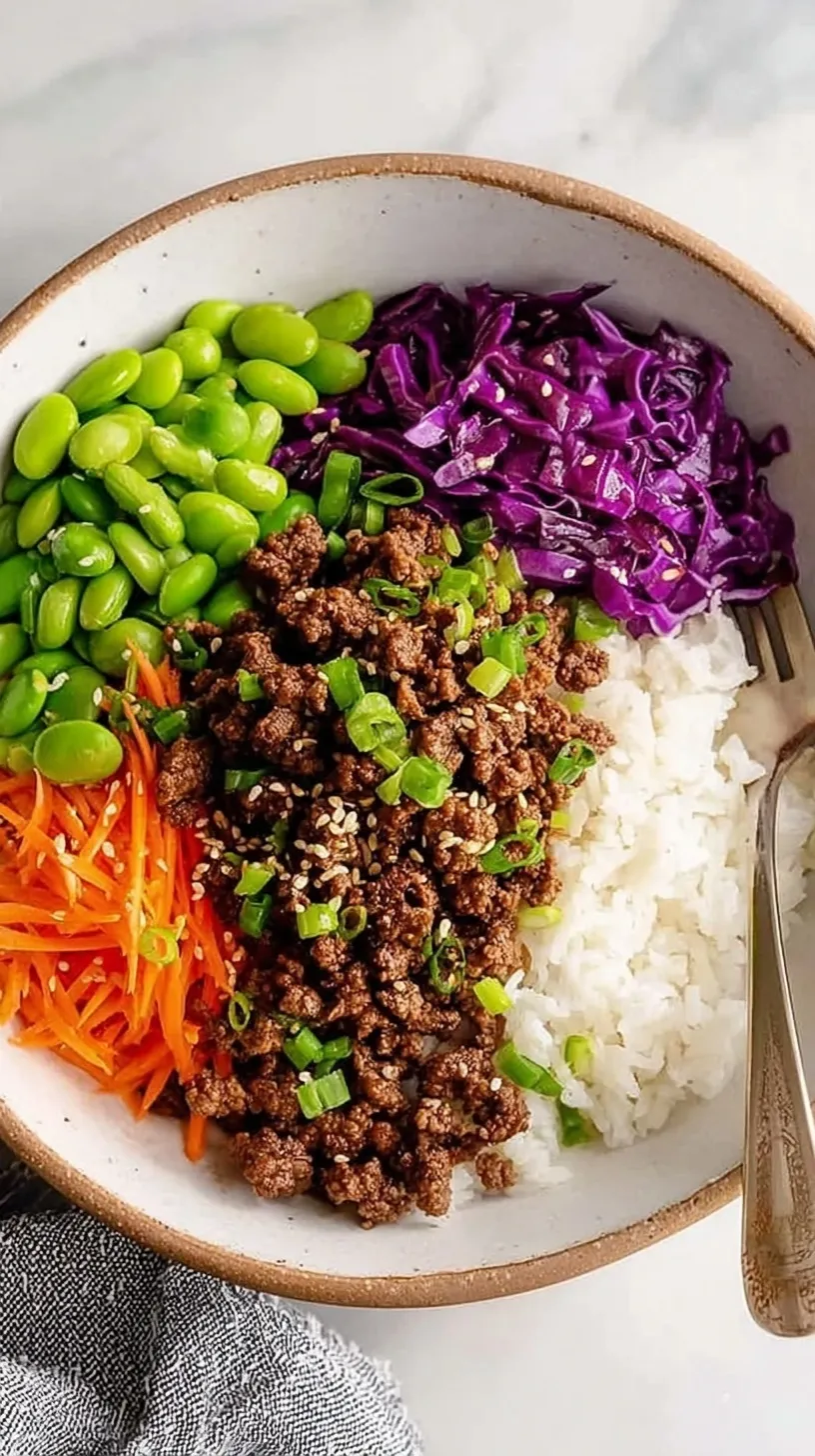 A bowl of glazed teriyaki ground beef with steamed broccoli and jasmine rice.