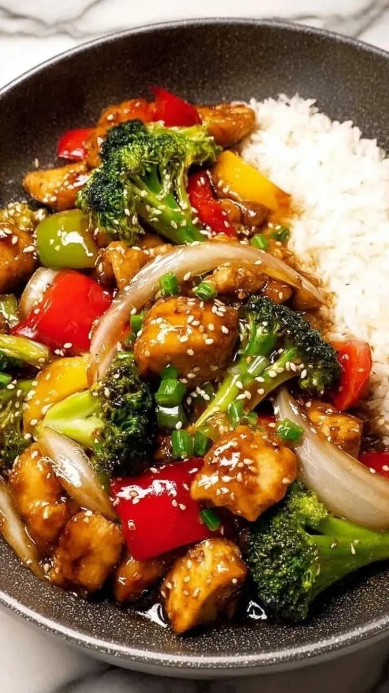 A glossy Teriyaki Chicken Stir Fry with broccoli and peppers served in a wok