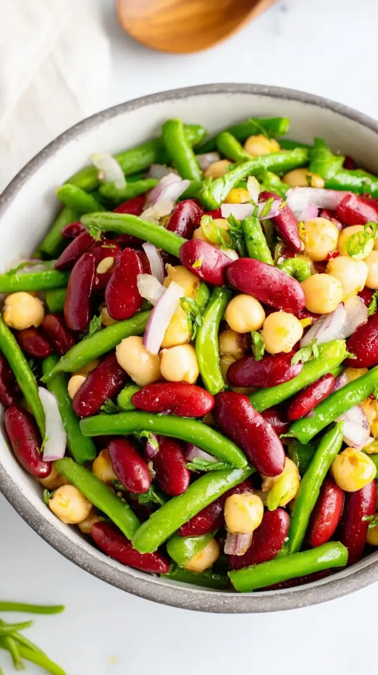 A colorful bowl of marinated three bean salad with green beans, wax beans, and kidney beans