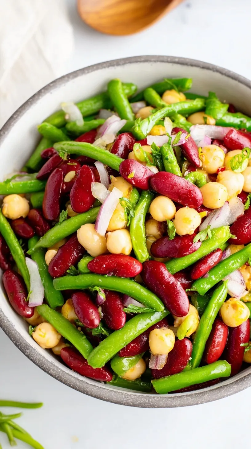 A colorful bowl of marinated three bean salad with green beans, wax beans, and kidney beans
